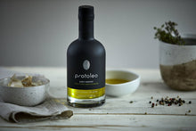 Load image into Gallery viewer, Premium Greek extra virgin olive oil PROTOLEO on the table with garlic, herbs and pepper. 

